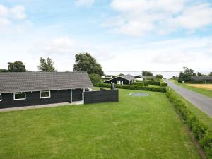 a house with a green lawn in front of a house at 14 person holiday home in Faaborg in Bøjden