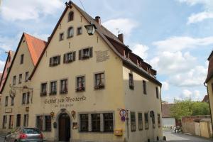 ein Gebäude mit einem davor geparkt in der Unterkunft Hotel Zum Breiterle in Rothenburg ob der Tauber