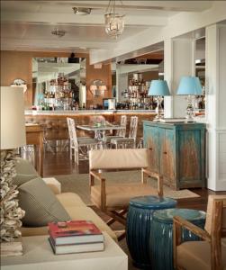 a living room with a couch and a bar at The Tides Beach Club in Kennebunkport
