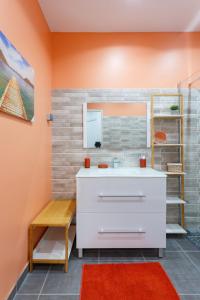 a bathroom with a sink and a mirror at Domaine de Sainval in Sainte-Rose
