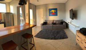 a living room with a couch and a table at Apartamento ao lado da UFOP com garagem in Ouro Preto