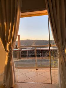 a room with a large window with a view at Apartamento ao lado da UFOP com garagem in Ouro Preto