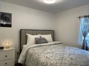 a bedroom with a bed and a window at By the Bay Cottages in Stanhope