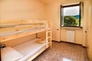 a room with two bunk beds and a window at Residence Corte del Bosco in Garda +90 photos