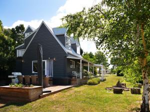 a black house with a porch and a yard at Morton House in Glenlyon