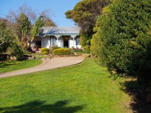 a house with a road leading to a yard at Gladville- old world charm with stunning views in Daylesford +7 photos