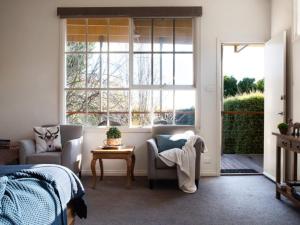 a bedroom with a bed and a window and a table at Daylesford House Studio in Daylesford