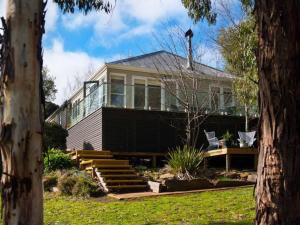 a large house with glass windows and a porch at Lake Como Villa in Daylesford