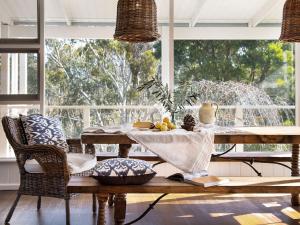 a dining room with a table and a window at Green Gully House in Glenlyon