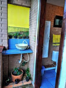 a small bathroom with a sink and a toilet at Espaço Mezanino in Mairiporã