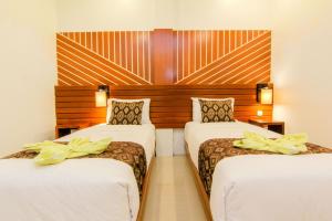 Postel nebo postele na pokoji v ubytování S5 Guest House Yogyakarta