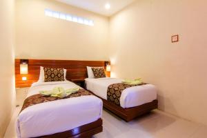 Postel nebo postele na pokoji v ubytování S5 Guest House Yogyakarta