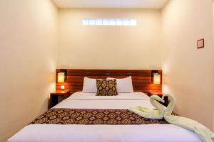 Postel nebo postele na pokoji v ubytování S5 Guest House Yogyakarta