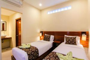 Postel nebo postele na pokoji v ubytování S5 Guest House Yogyakarta