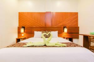 Postel nebo postele na pokoji v ubytování S5 Guest House Yogyakarta