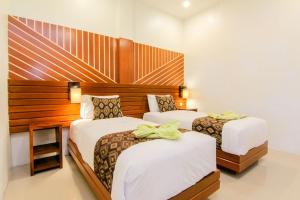 Postel nebo postele na pokoji v ubytování S5 Guest House Yogyakarta