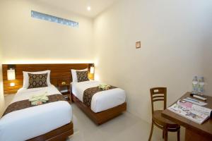 Postel nebo postele na pokoji v ubytování S5 Guest House Yogyakarta