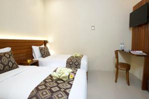 Postel nebo postele na pokoji v ubytování S5 Guest House Yogyakarta