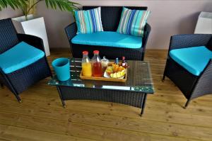 a tray of fruit and drinks on a table in a living room at Cosy By Mélanie - Un hôtel comme chez vous in Fort-de-France