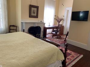 a bedroom with a bed and a fireplace at 1872 Denham Inn in Monticello
