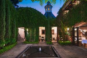 an estate with a fountain in the middle of a garden at El Convento Boutique Hotel in Antigua Guatemala
