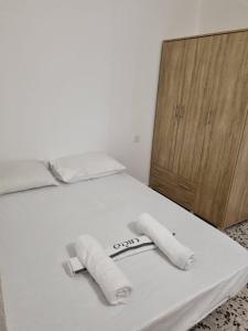 białe łóżko z dwoma ręcznikami na górze w obiekcie דירה במדבר w Ejlat
