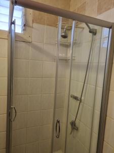 W łazience znajduje się prysznic ze szklanymi drzwiami. w obiekcie דירה במדבר w Ejlat
