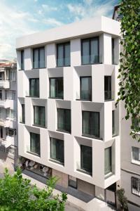 an exterior view of a white apartment building at The Pearl Suites in Istanbul