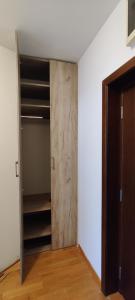 Cette chambre comprend un placard avec une porte en bois. dans l'établissement Apartman Kata, à Vrnjačka Banja