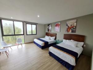 เตียงในห้องที่ Casa Arandas Hotel - Suits