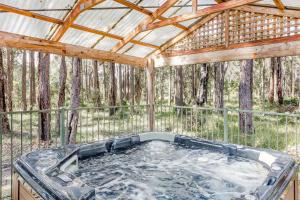 a hot tub in a gazebo in the woods at The Grove Distillery & Brewery in Wilyabrup