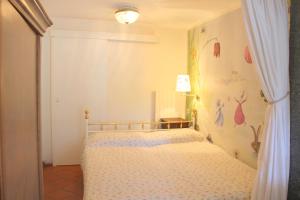 a bedroom with a bed with a flower wall at Barony romantic villa in Lugano +42 photos