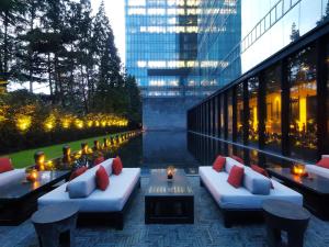 a building with two couches and a table with candles at The Puli Hotel And Spa in Shanghai