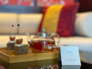 a tray with a tea kettle on a table at Banyan Tree Chongqing Beibei in Chongqing