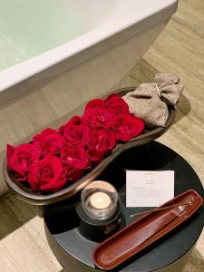 a tray of red roses and a candle on a table at Banyan Tree Chongqing Beibei in Chongqing