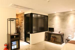a bedroom with a desk and a computer in a room at Hotel Banwol Asiad in Incheon