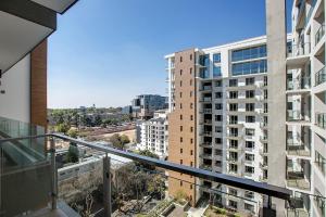 an apartment balcony with a view of a city at The Serviced Apartment Collection At The Tyrwhitt Rosebank in Johannesburg