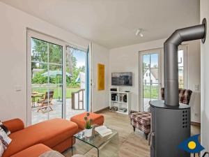 a living room with a large wood stove in it at Fischerdorf Zirchow Käptn 12 B in Zirchow