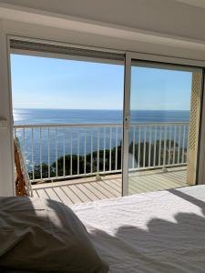 a bedroom with a view of the ocean from a balcony at wonderfull view cap d ail monaco in Saint-Antoine