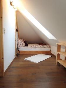 a attic room with a bed under a roof at Ferienhaus "Platzhirsch" in Hollenstein an der Ybbs
