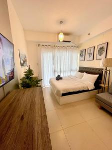 a bedroom with a large bed and a window at Cozy @ Cool in Tagaytay +29 photos
