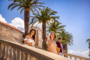 two women and a man posing for a picture at Marko Polo Hotel by Aminess in Korčula