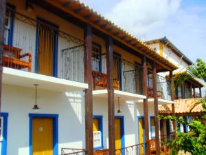 a row of houses with colorful doors and windows at Pousada Toque Mineiro in Tiradentes