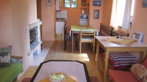 a living room with a table and a dining room at Bungalov Tina in Žiar