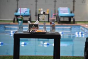 a table with a plate of food and two bottles of water at Jeddah Oasis Hotel in Jeddah