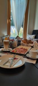 a table with plates of food on top of it at 23-hotel in Schwadorf