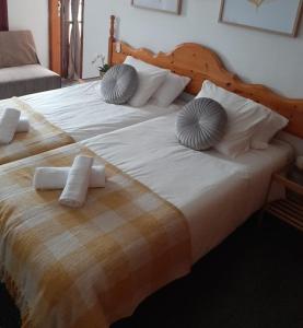 a large bed with two pillows on top of it at ApartamentosPlaya_Hermigua in Hermigua