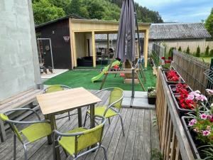 eine Terrasse mit einem Tisch, Stühlen und einem Sonnenschirm in der Unterkunft Apartment WELLNESS Vlčková in Vlčková