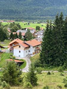 a group of houses on a hill with trees at Unser Dahoam in Wallgau