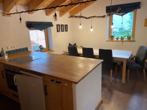 a kitchen and dining room with a table and chairs at Unser Dahoam in Wallgau +9 photos